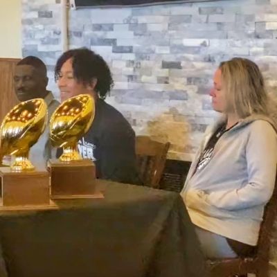 Peyton Bowen is sitting in the middle with Winston Bowen and Amee Bowen sitting next to him.